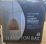 Hampton Bay Highler 1-LIGHT 18 In. Matte Black Pendant Natural Rattan Shade. Fixed Price $49.99.